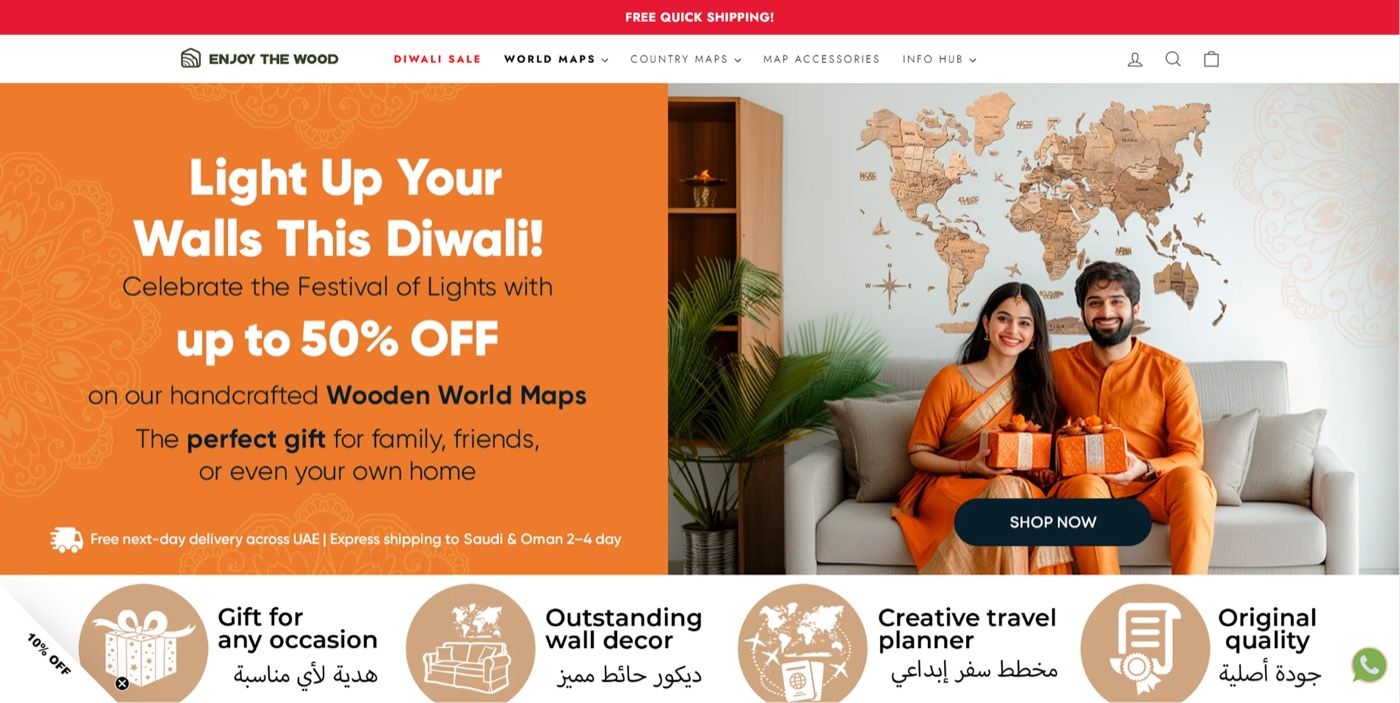 Enjoy The Wood home page with a festive promo banner, a wooden world map and benefit icons in English and Arabic.