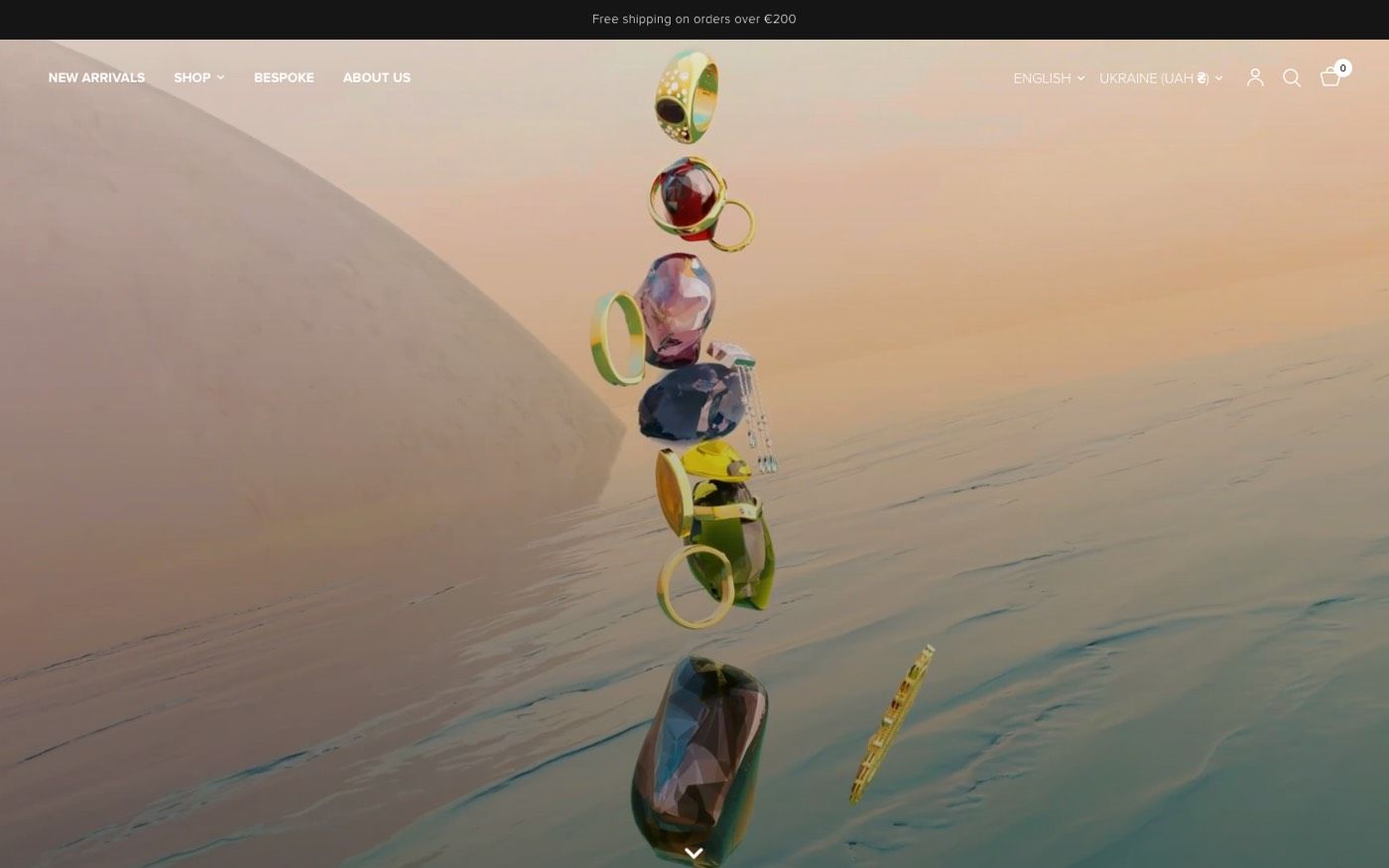 KOZI home page with a full-screen video of floating rings and a scroll arrow.